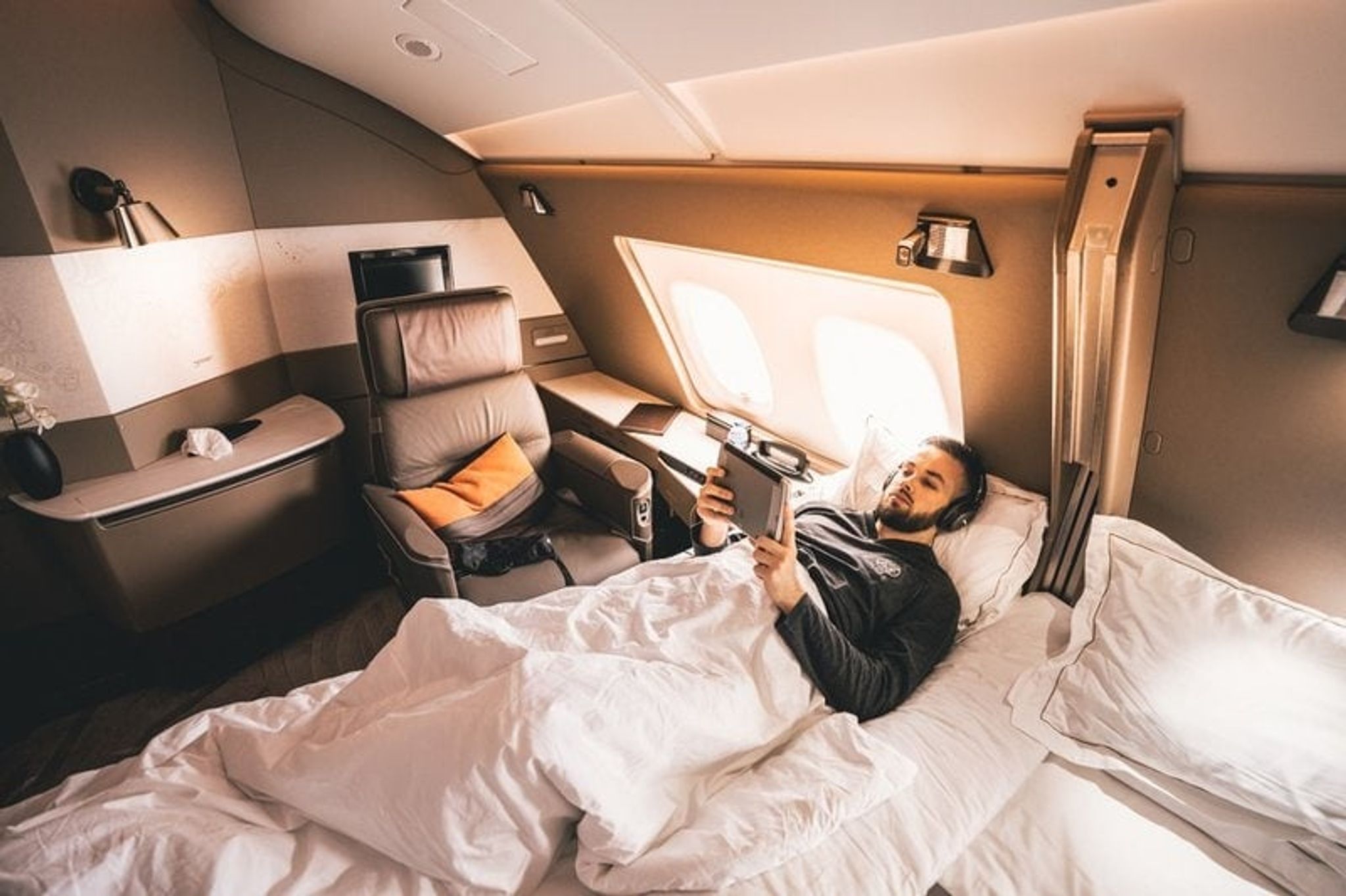 Passenger relaxing on the bed in the Singapore Airlines A380 Suites