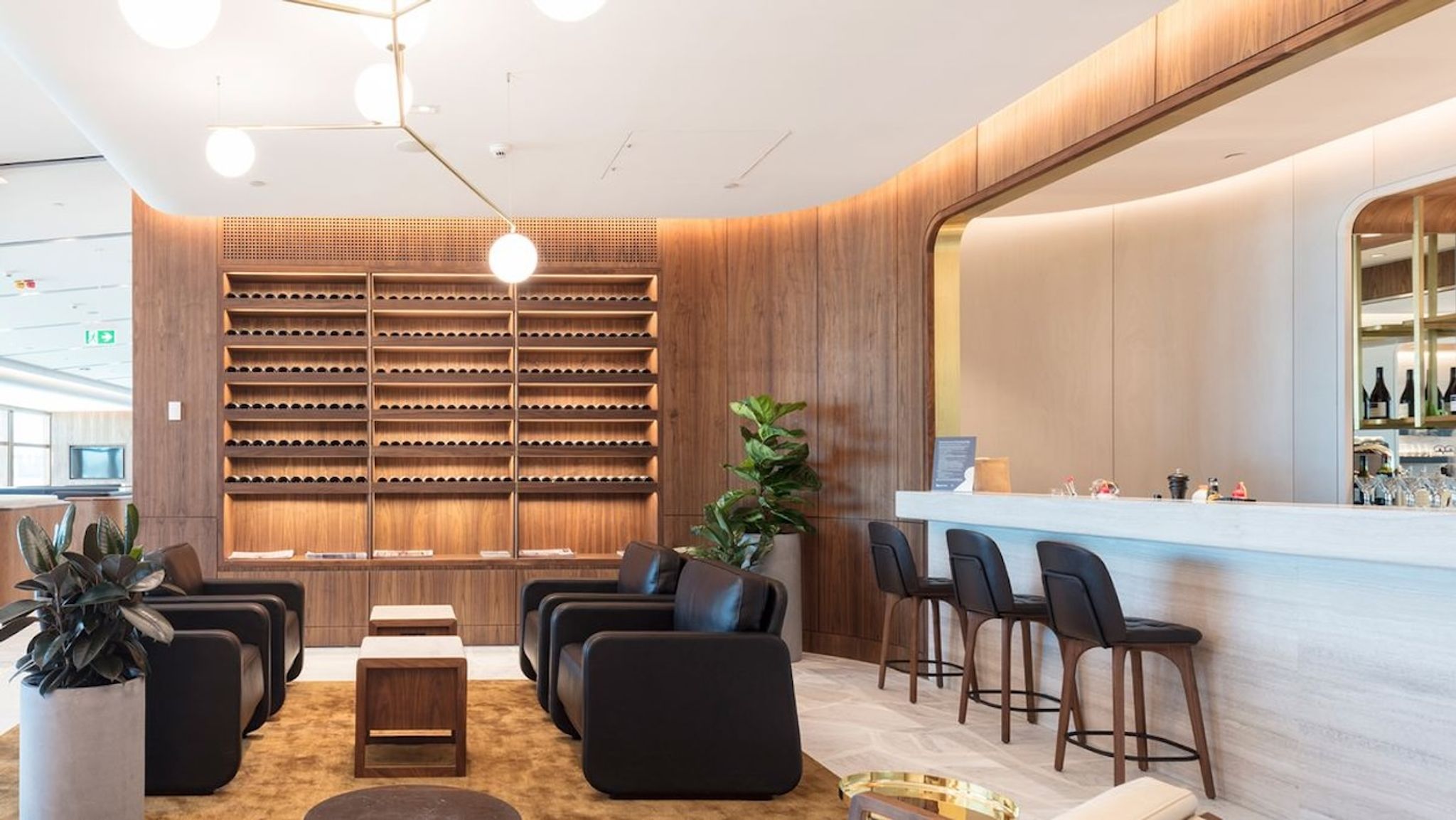 Airport lounge with a wine wall, leather armchairs and a bar