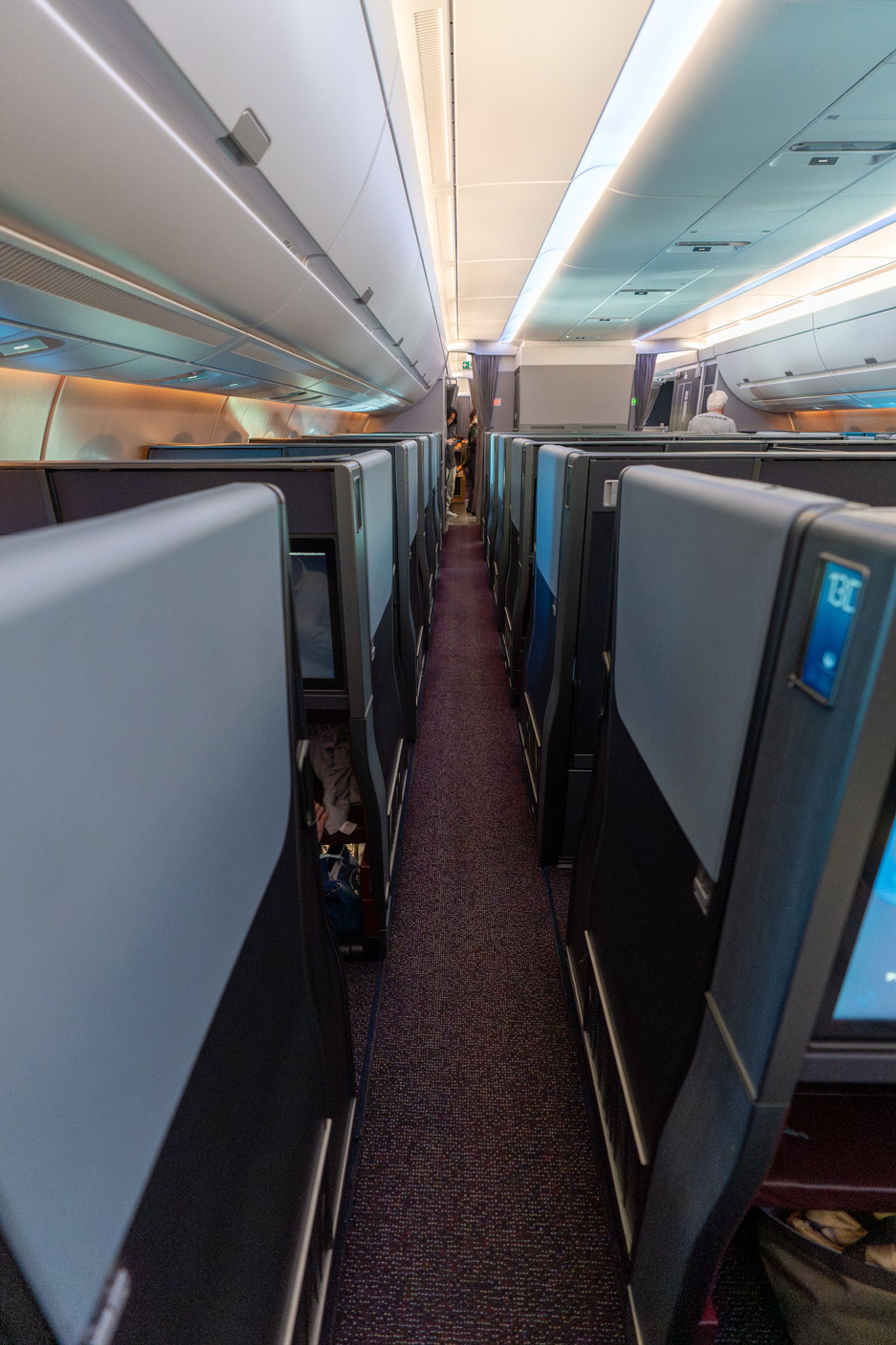 Aisle of the Japan Airlines A350-1000 business class cabin with enclosed suites