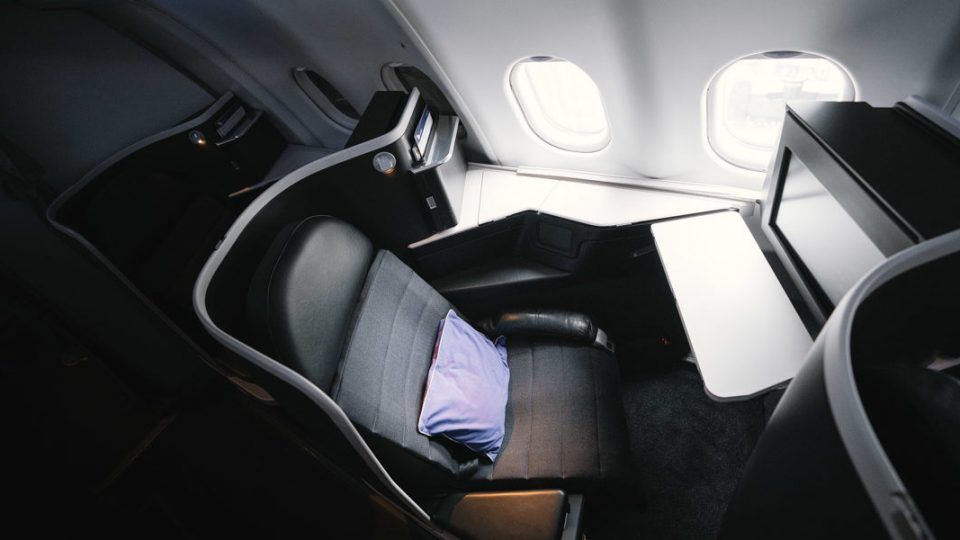 Lie-flat business class seat beside the aircraft windows