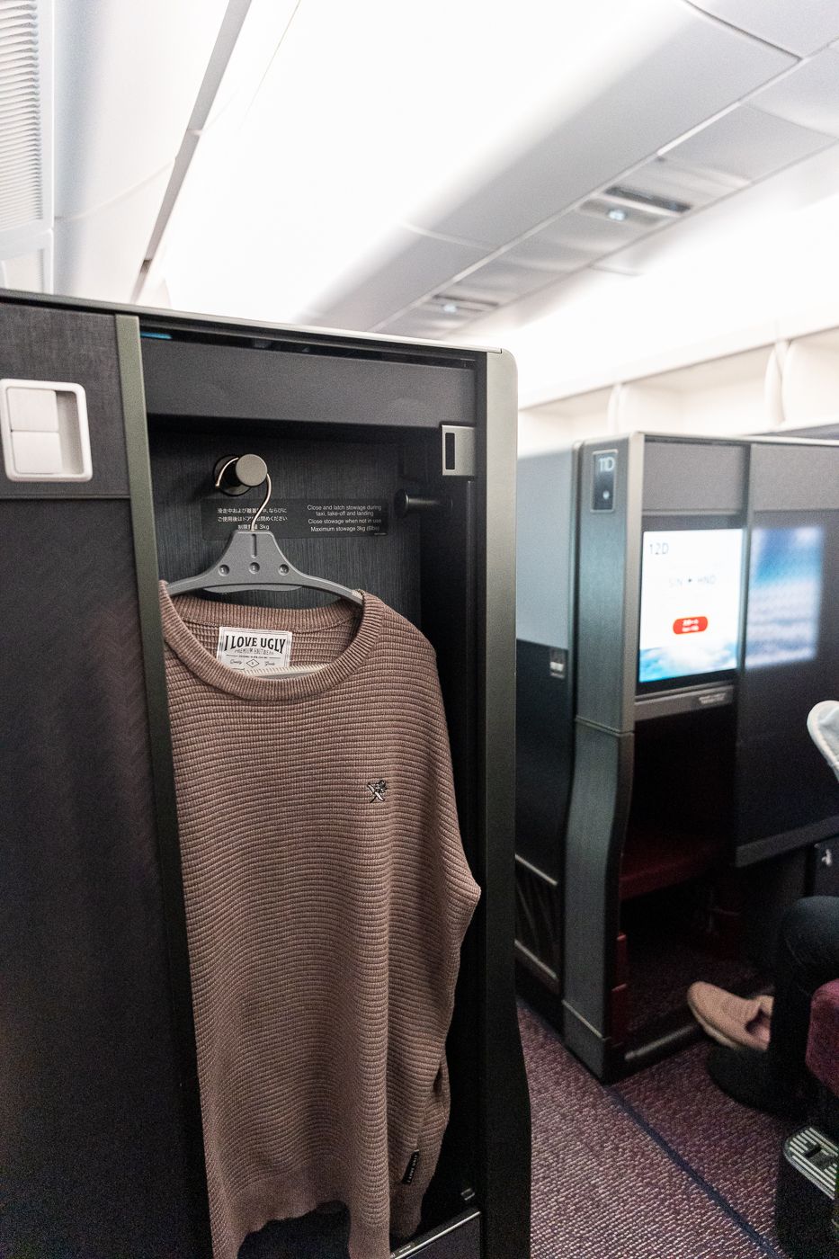 Wardrobe with a coat hanger beside the screen in Japan Airlines A350-1000 business class
