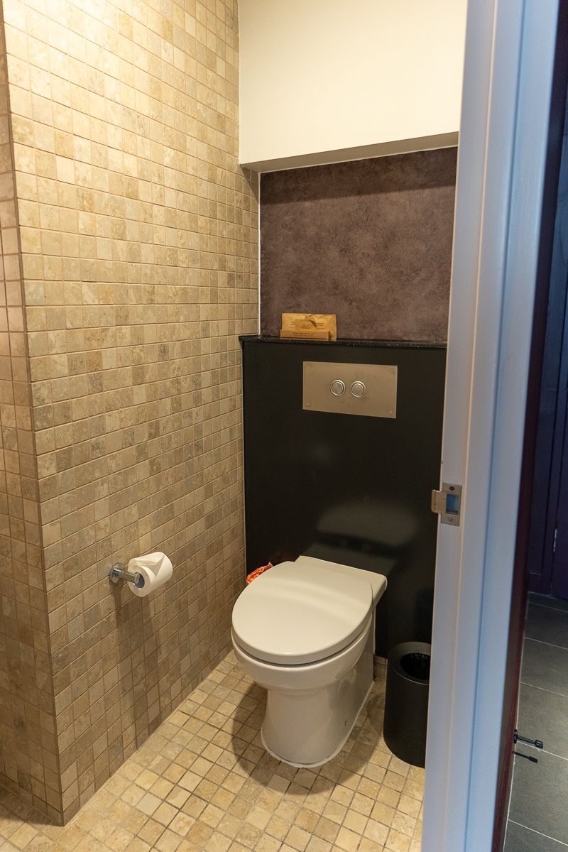 Toilet with tiled walls in the Hotel Indigo Sydney suite