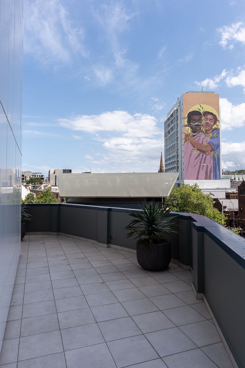 Terrace with views of a street mural and Potts Point at Hotel Indigo Sydney