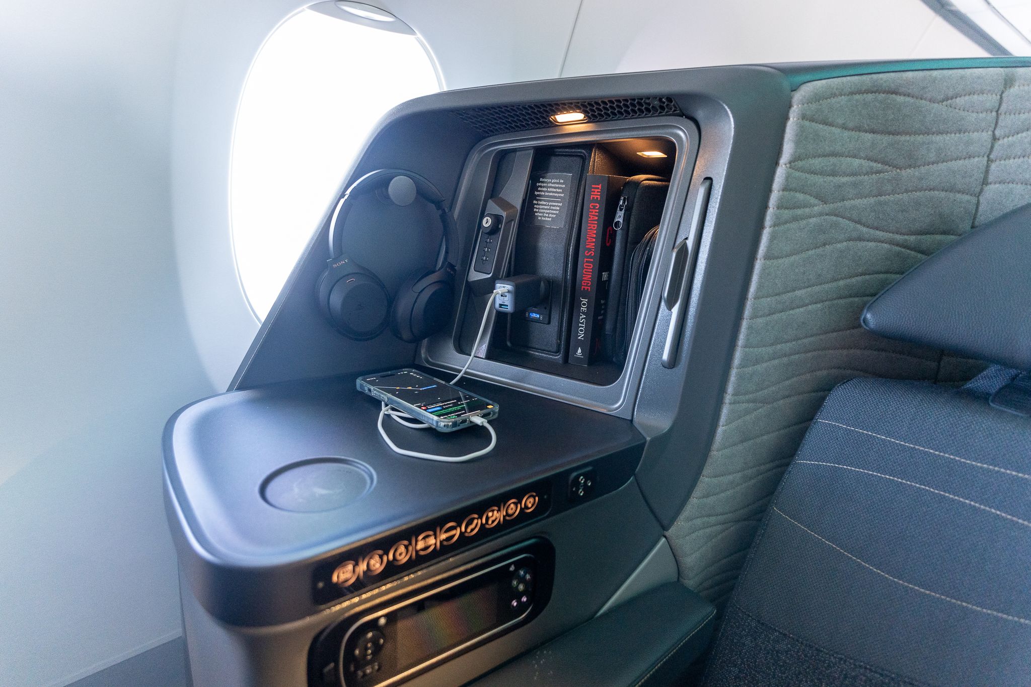Turkish Airlines A350 business class side storage with headphones and phone charging