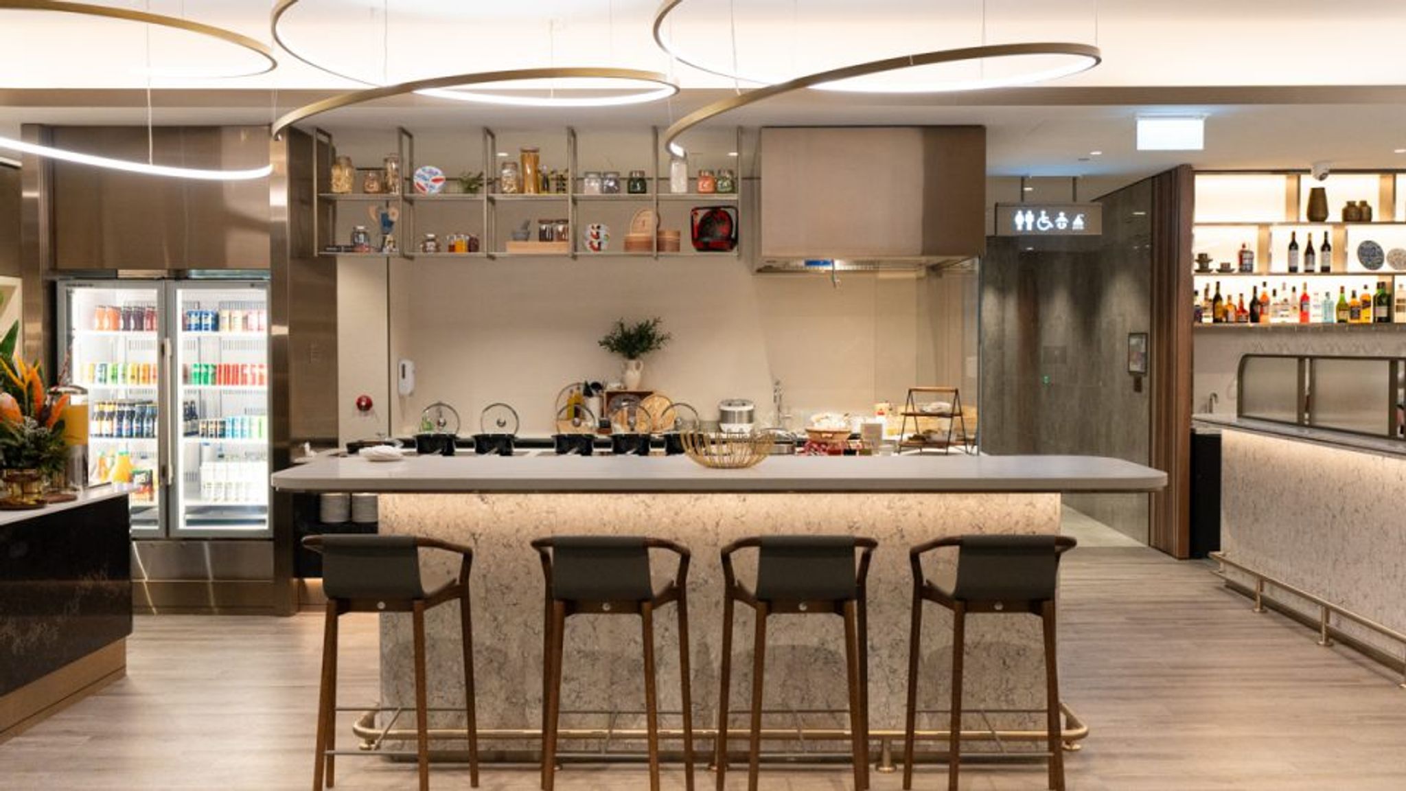 Bar and buffet counter with stools at the Singapore Airlines SilverKris Lounge in Perth