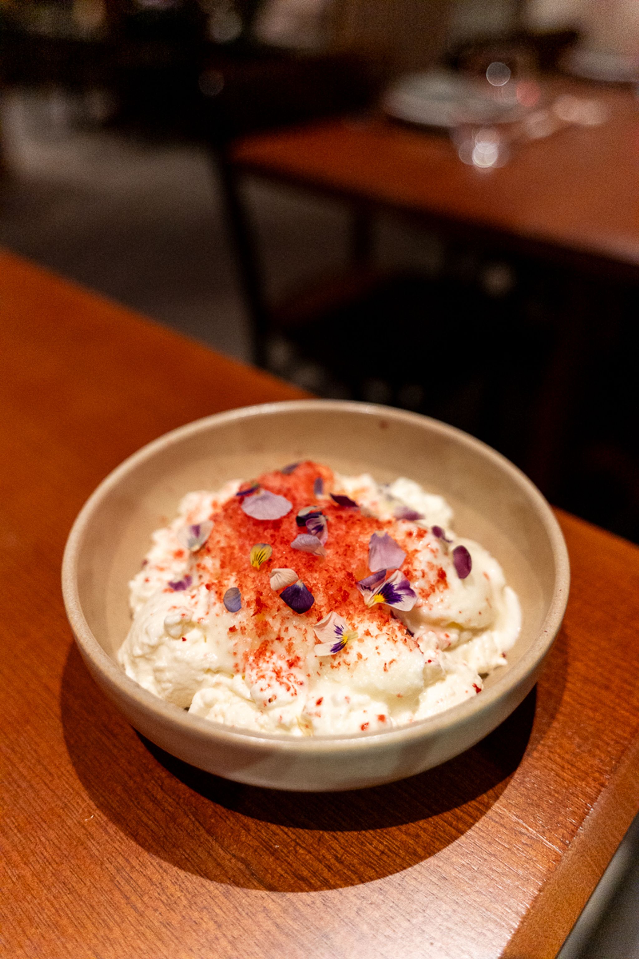 Dessert topped with edible flowers at Hotel Indigo Sydney