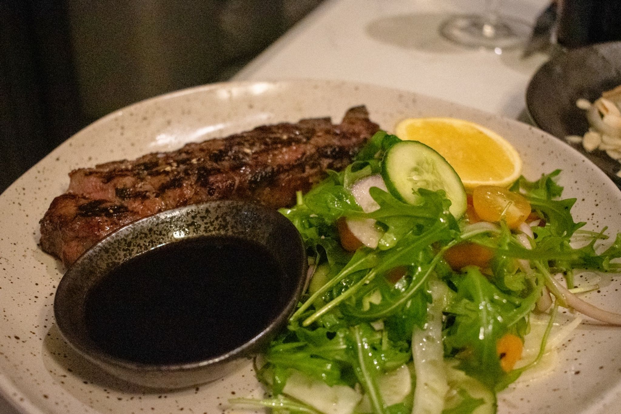 Steak with salad and jus at Mövenpick Hobart