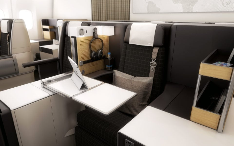 Swiss business class seat with a table and tablet