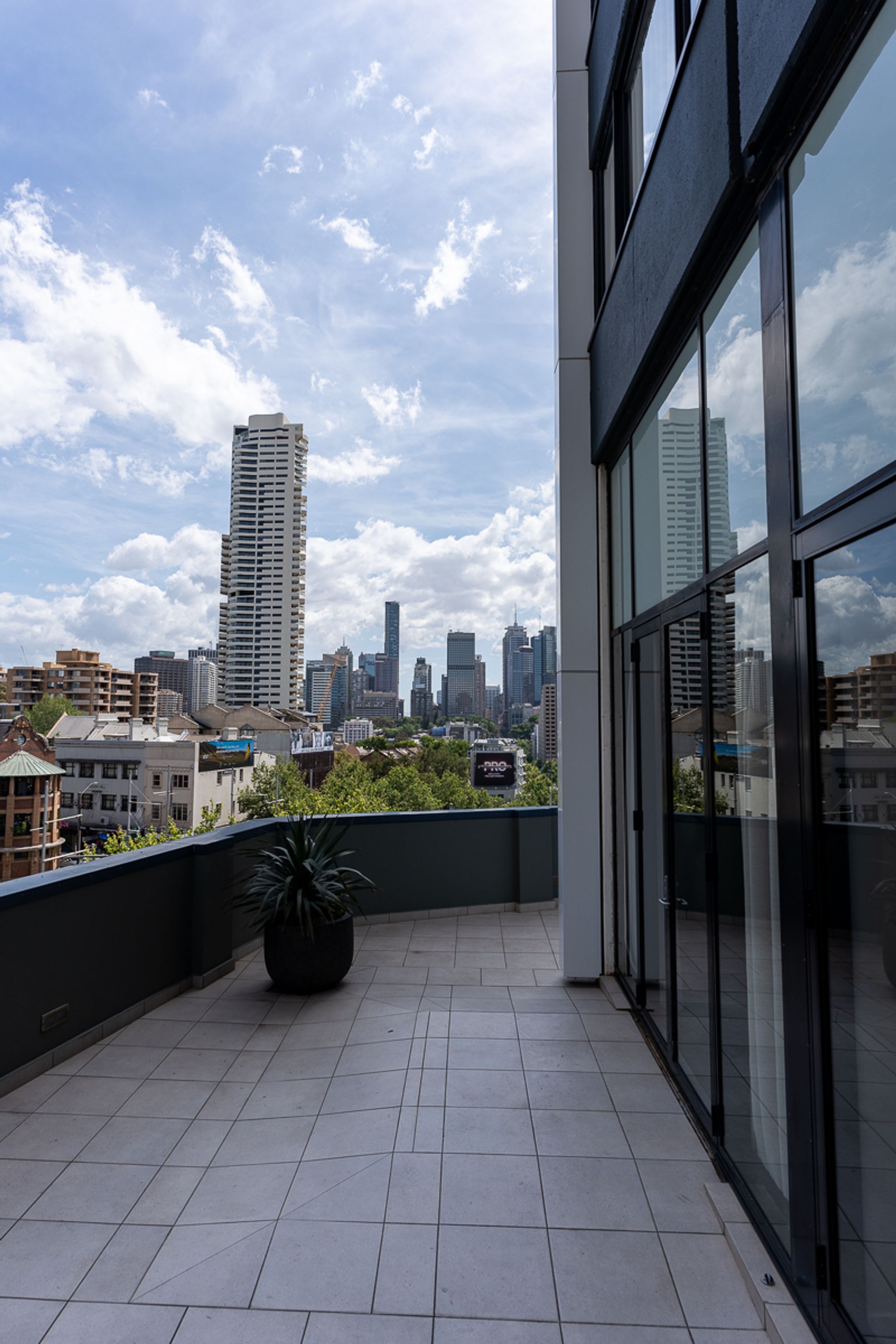 Terrace at Hotel Indigo Sydney with views of the Sydney CBD skyline
