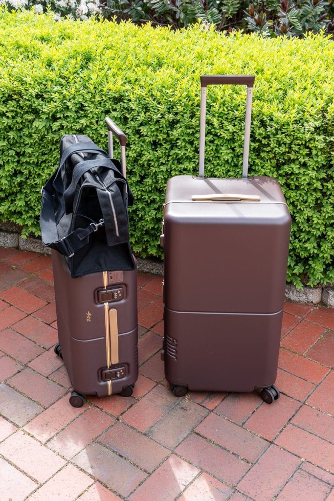 July suitcases with the Everyday Small Duffle bag on a carry-on handle