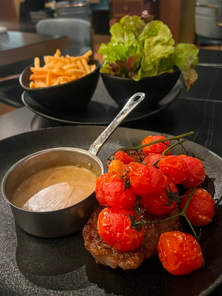 Scotch fillet with roasted vine tomatoes, fries and salad at Sofitel Adelaide