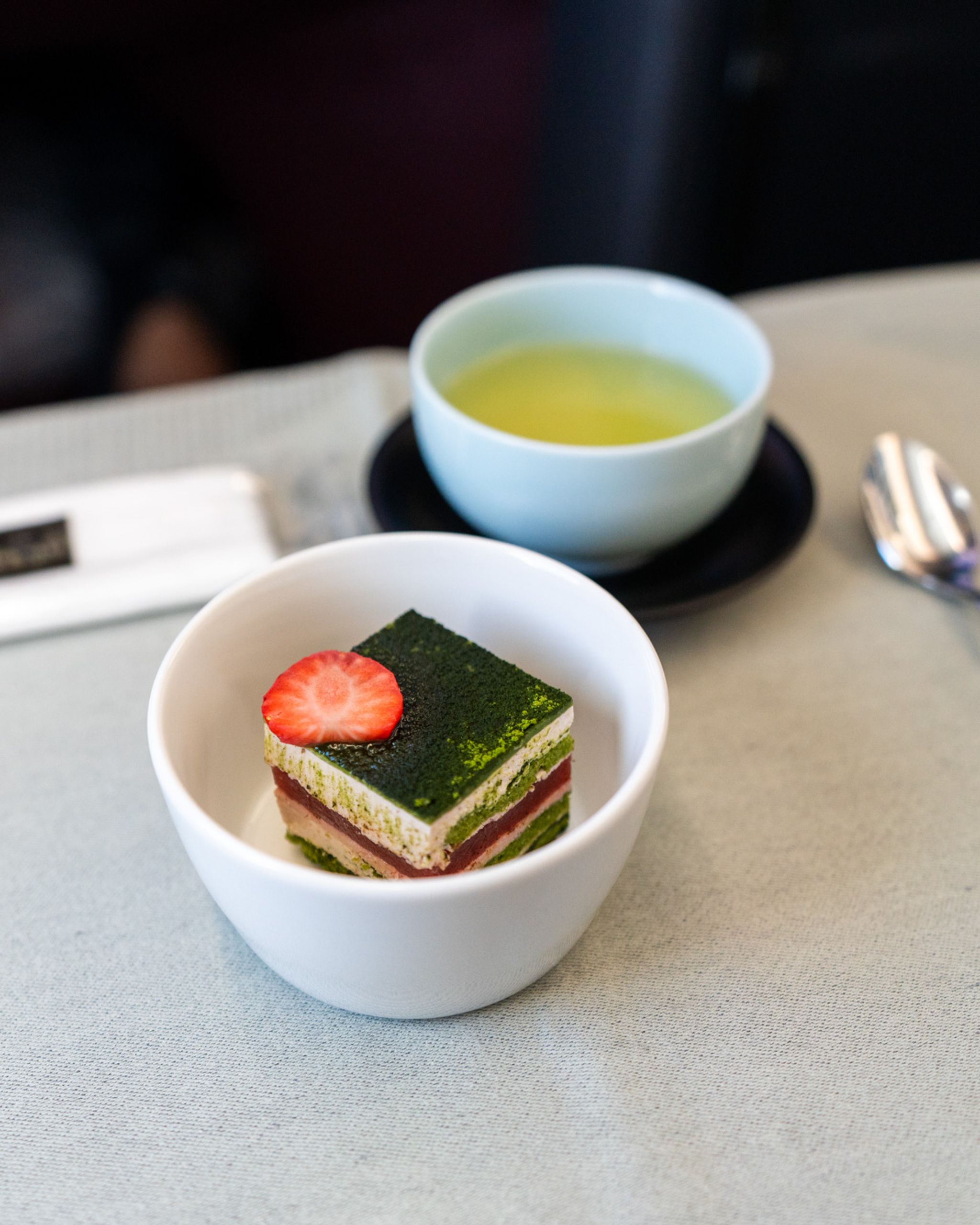 Strawberry matcha cake and green tea served in Japan Airlines business class