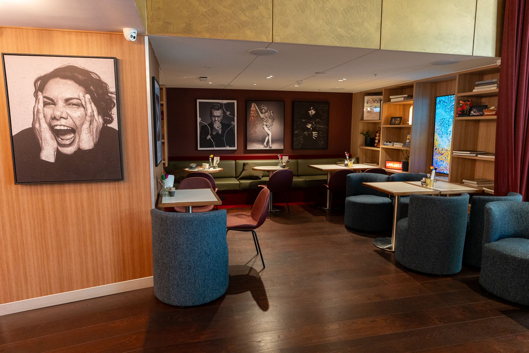 Lobby lounge with portrait artwork at Hotel Indigo Sydney Potts Point