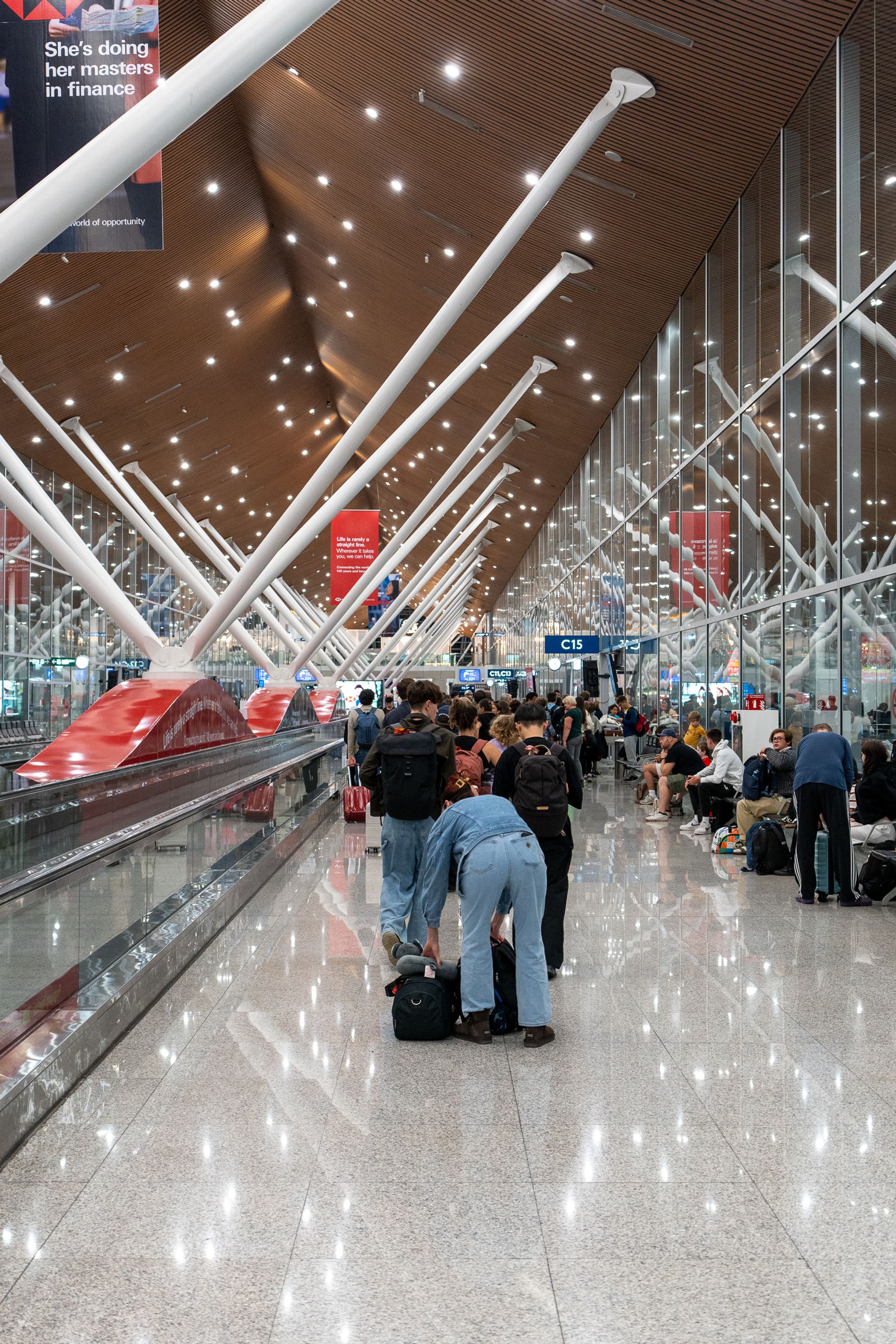 Busy airport terminal concourse with travellers