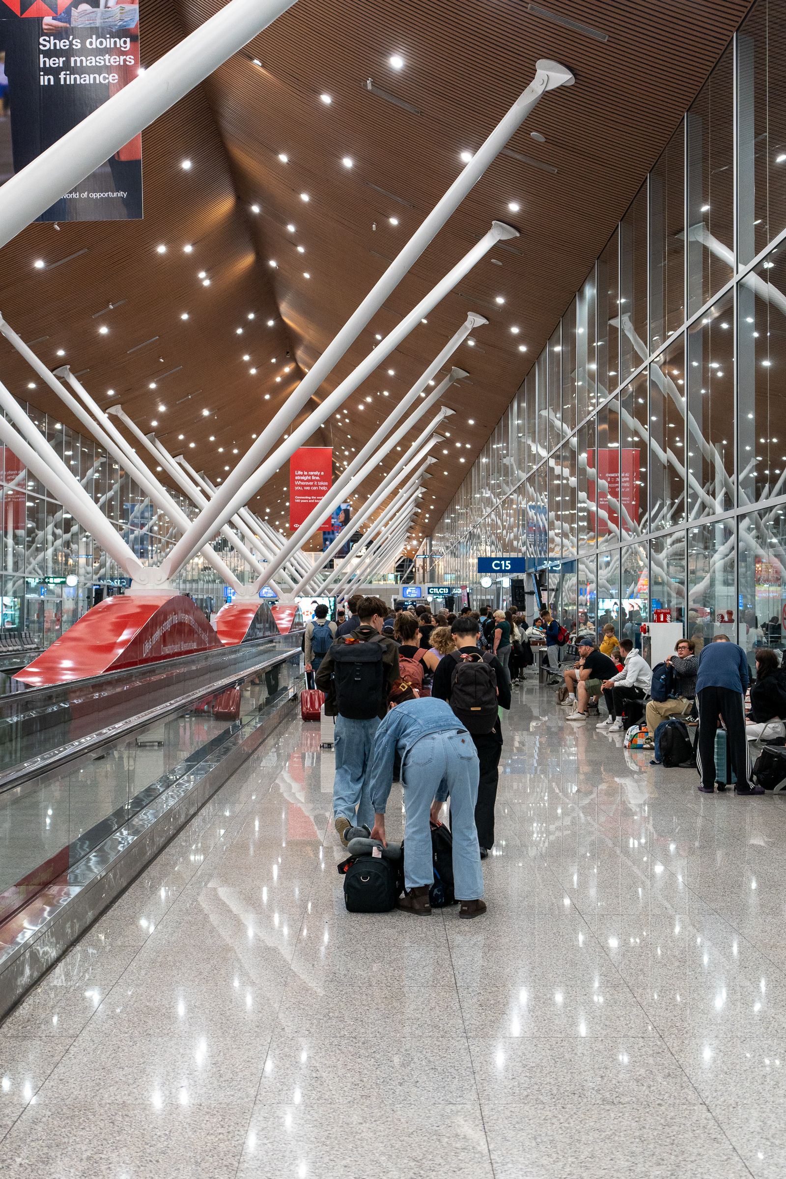 Busy airport terminal concourse with travellers