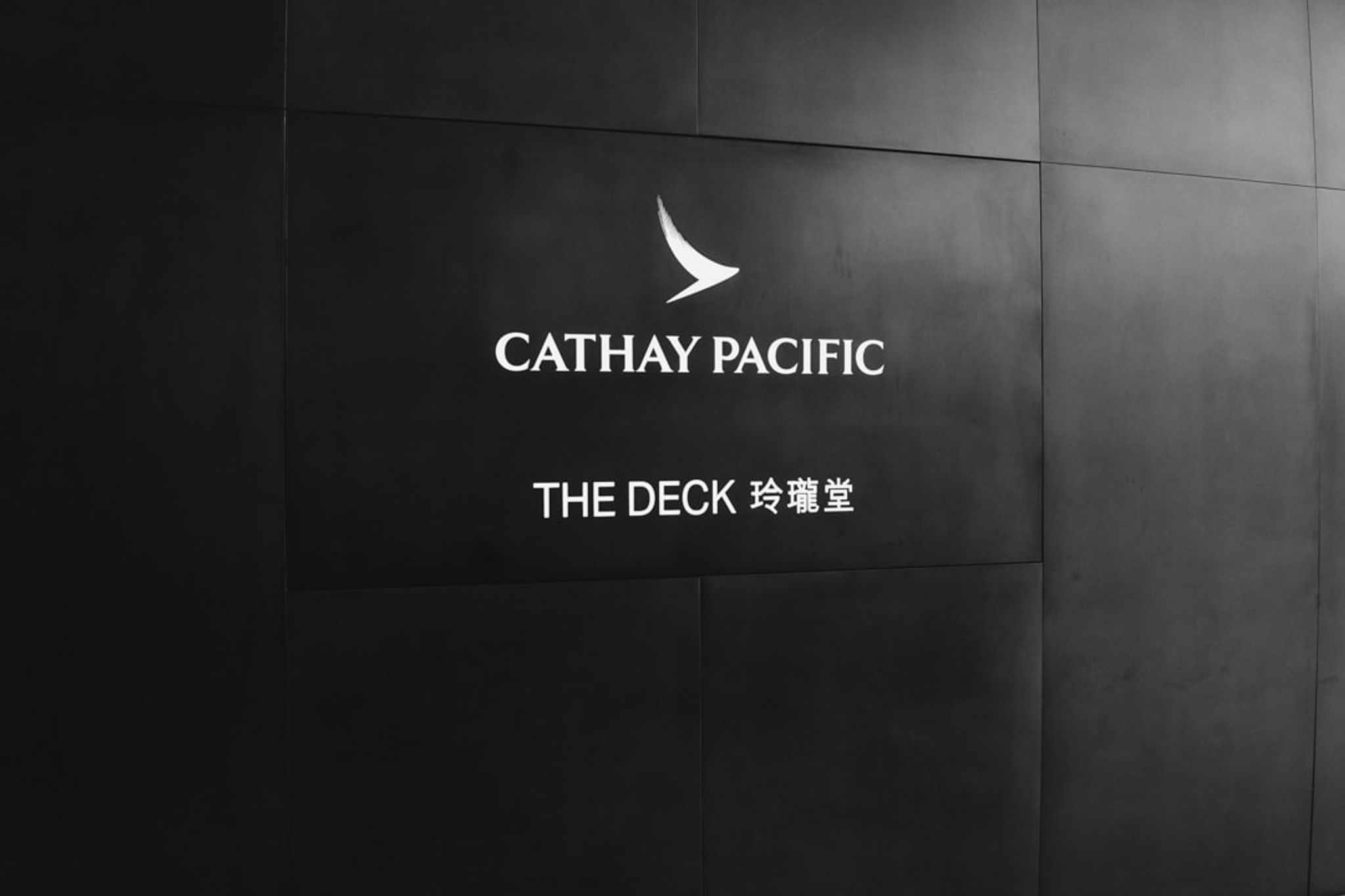 Cathay Pacific The Deck lounge sign on a dark wall