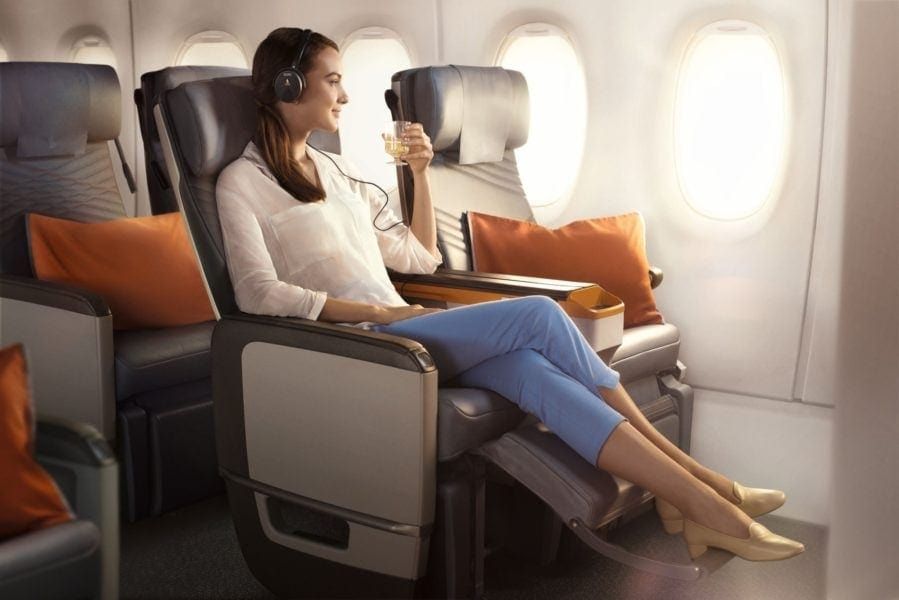 Passenger relaxing in a Singapore Airlines Premium Economy seat