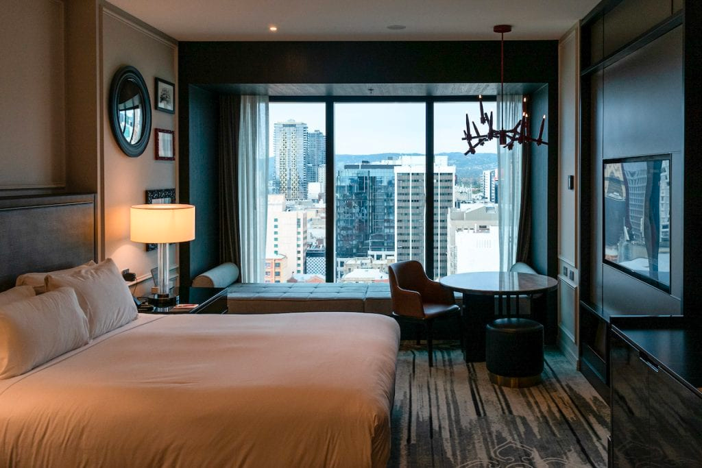 King bed and window lounge with views over Adelaide at Sofitel Adelaide