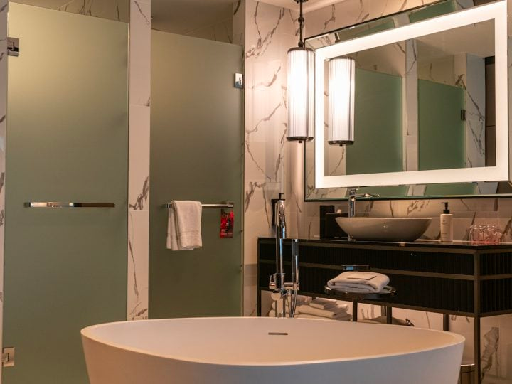 Freestanding bath, vanity and frosted shower doors at Sofitel Adelaide