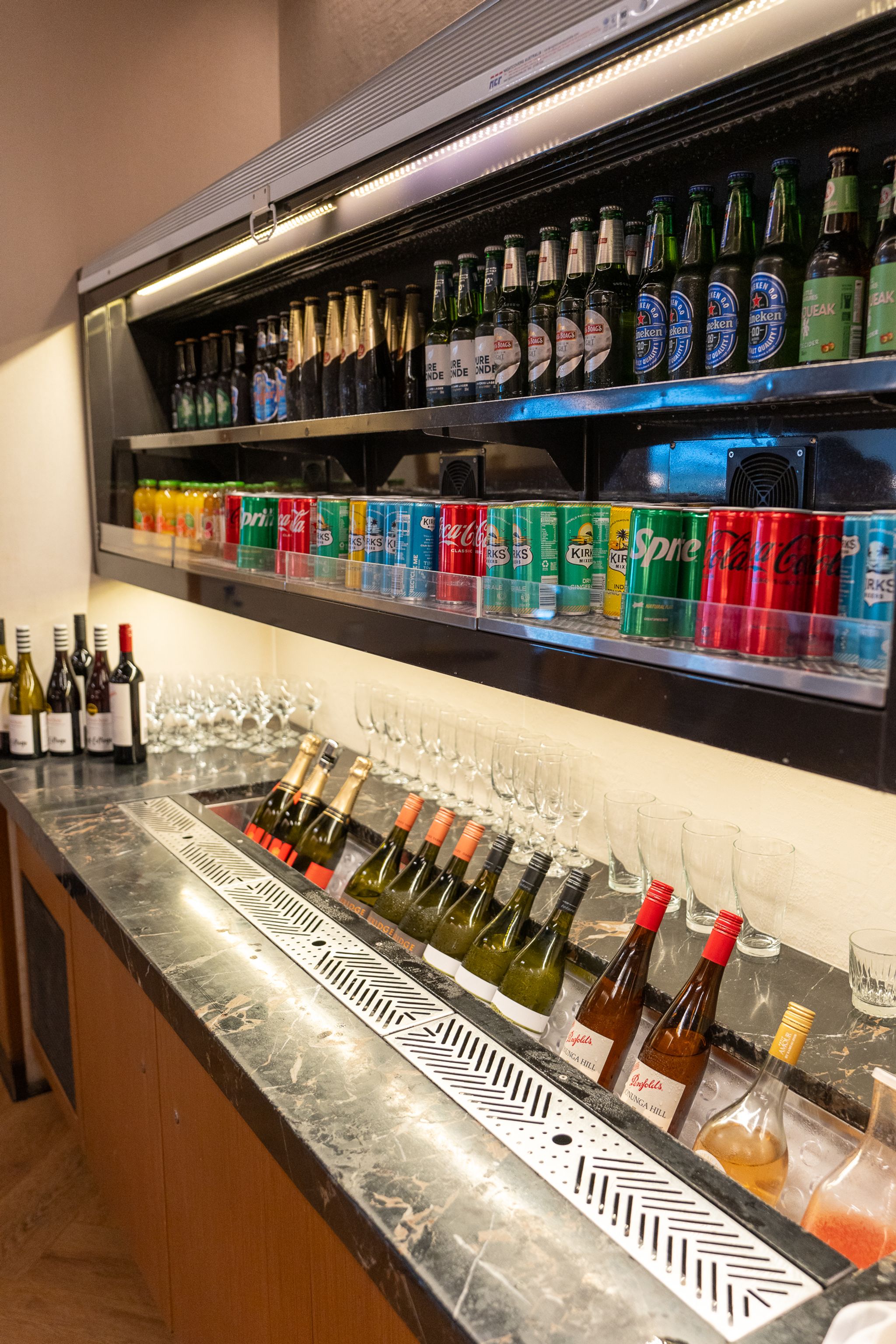 Free-pour bar with beers, soft drinks and wine on ice in the SilverKris Lounge, Sydney