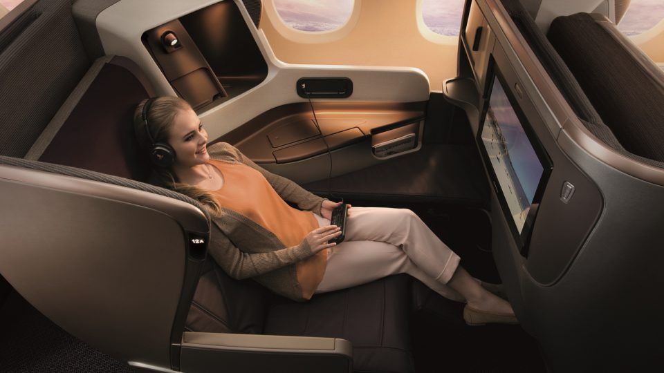 Passenger relaxing in a Singapore Airlines business class seat