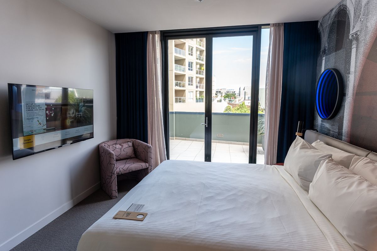 King bed facing balcony doors in a room at Hotel Indigo Sydney Potts Point