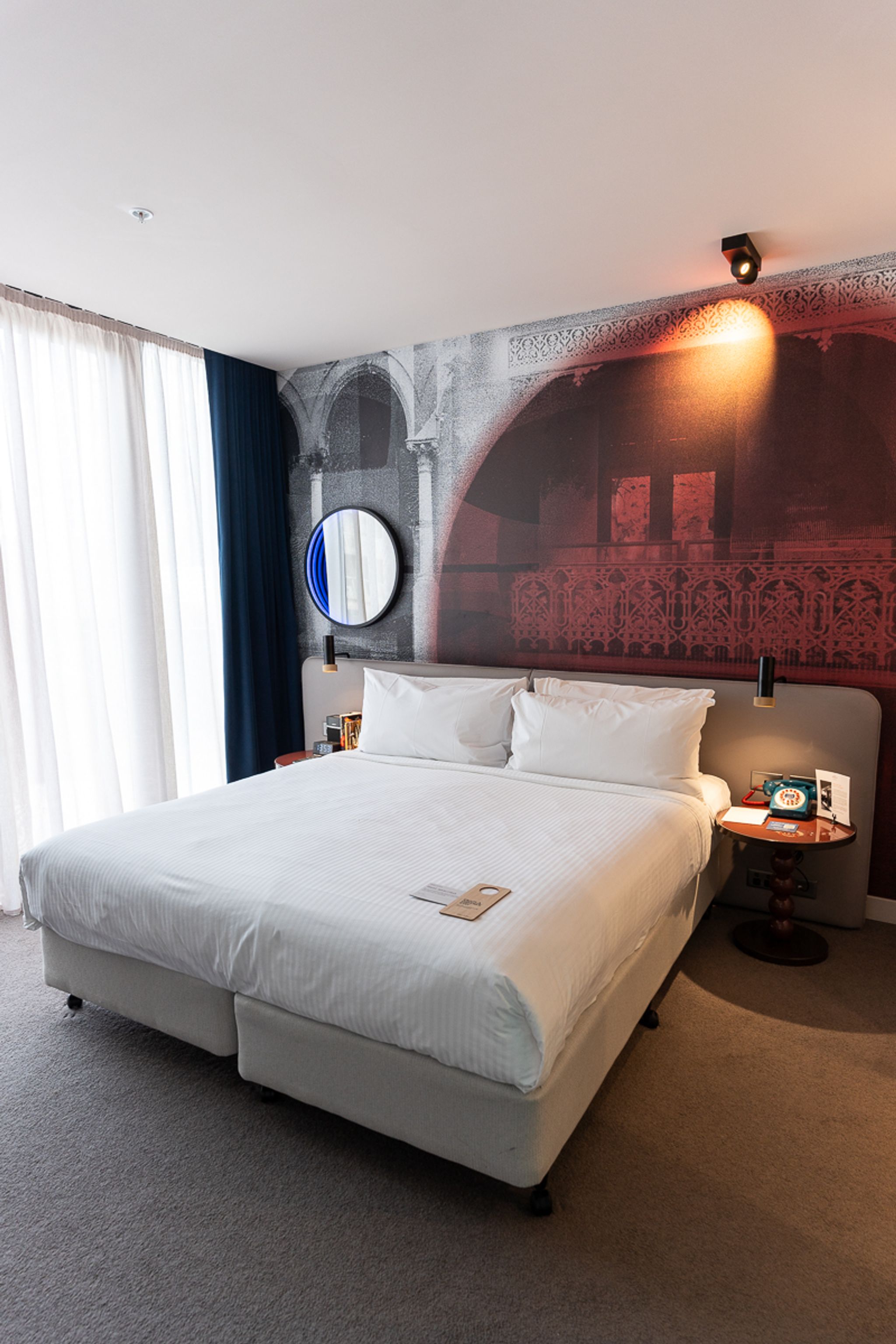 King bed against a feature wall mural at Hotel Indigo Sydney Potts Point