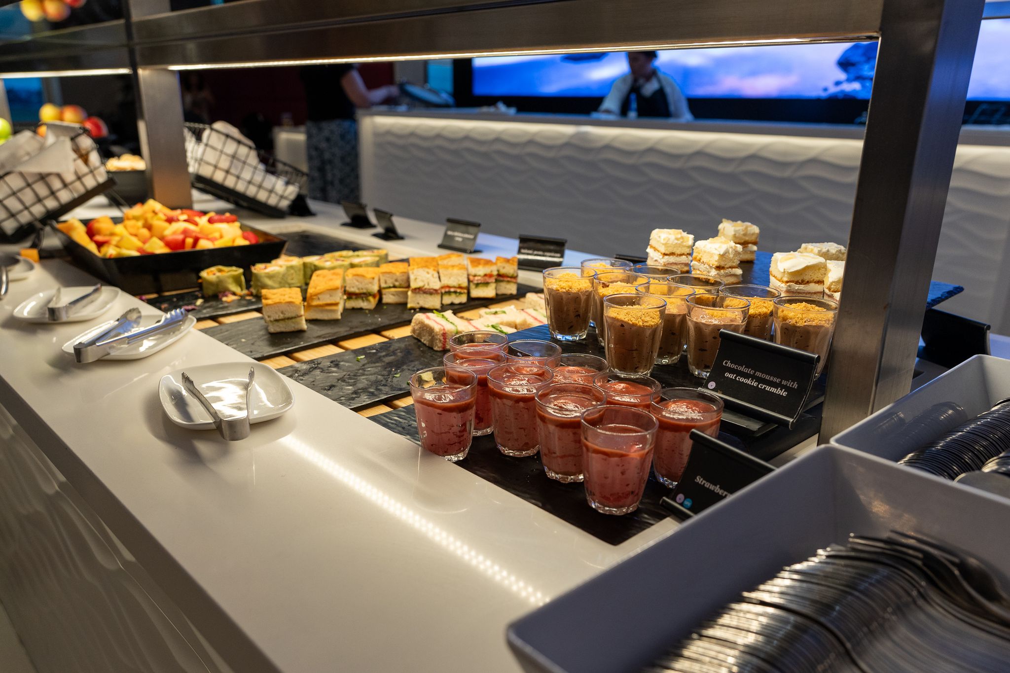 Lounge buffet with fruit, sandwiches and desserts in cups
