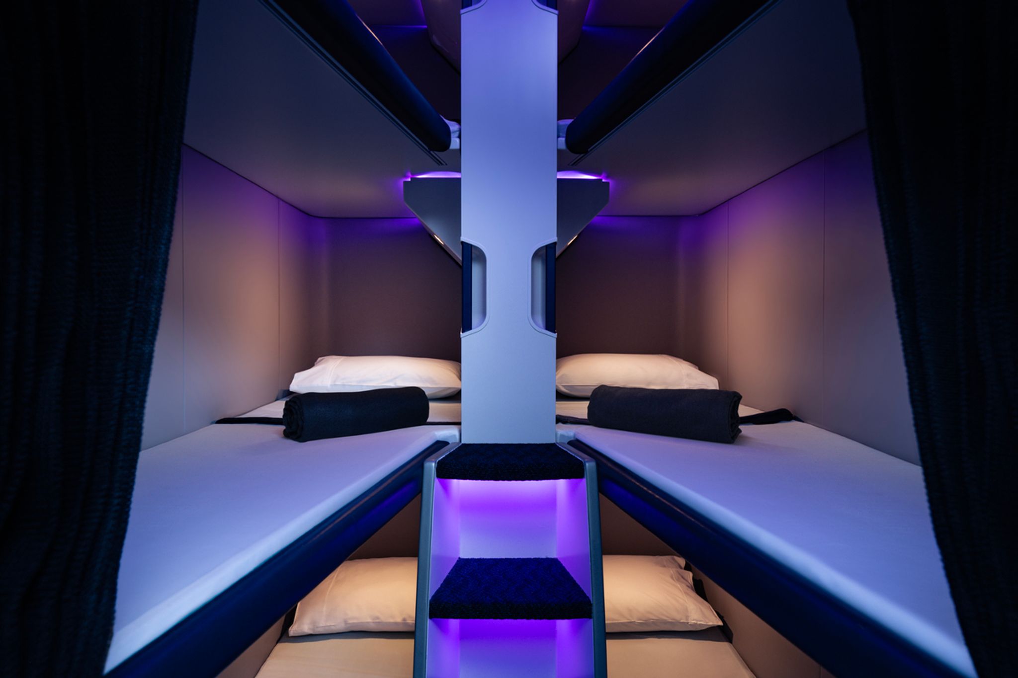 Air New Zealand Skynest bunk beds with pillows, blankets and privacy curtains