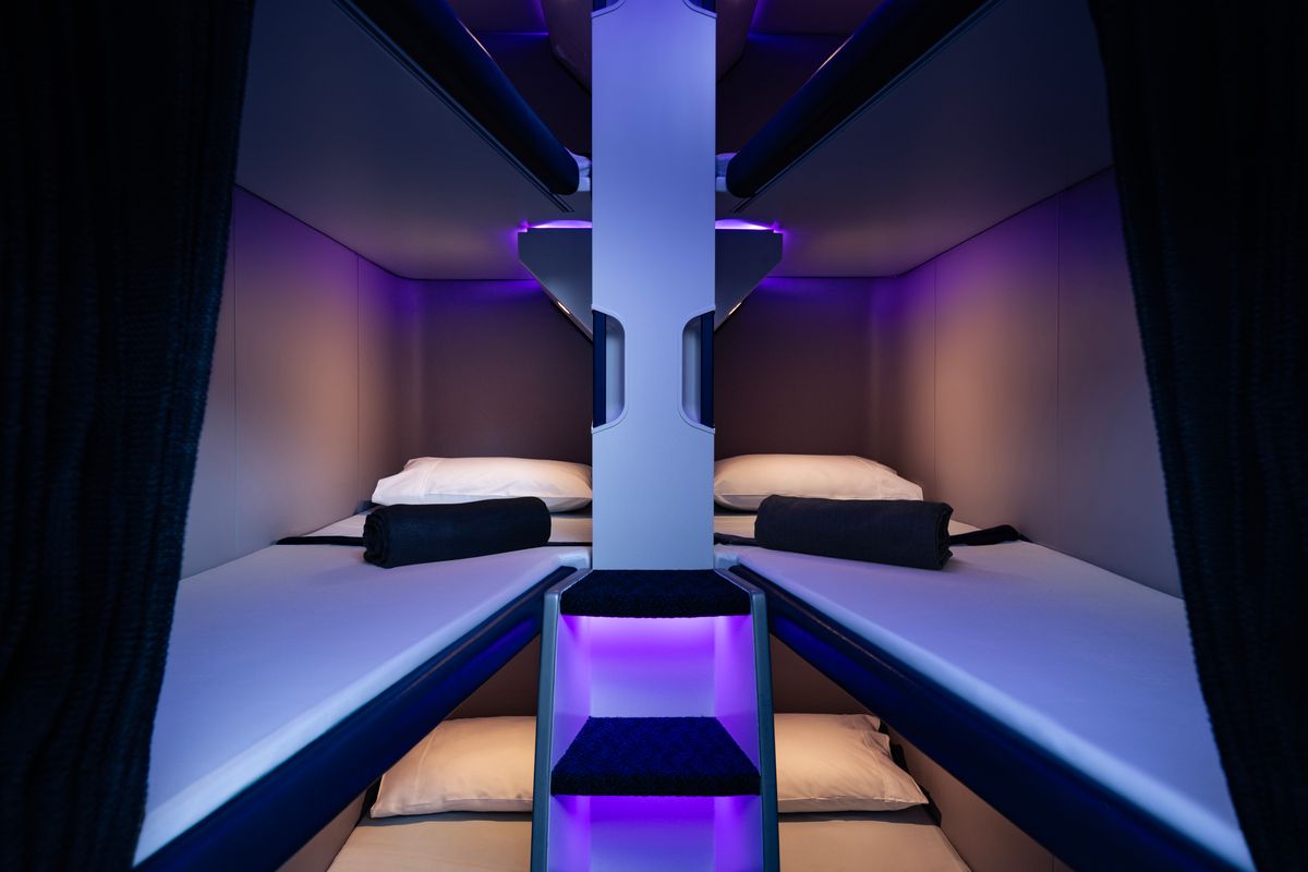 Air New Zealand Skynest bunk beds with pillows, blankets and privacy curtains