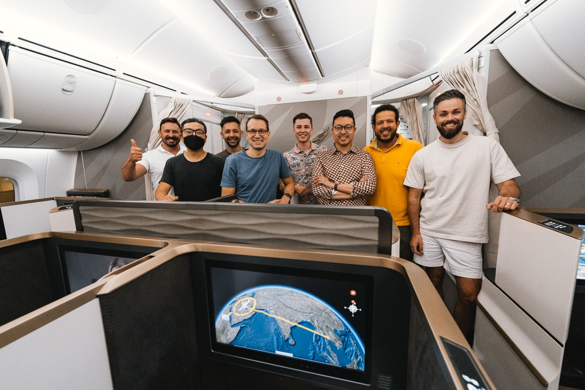 Group of travellers posing in the Gulf Air business class cabin