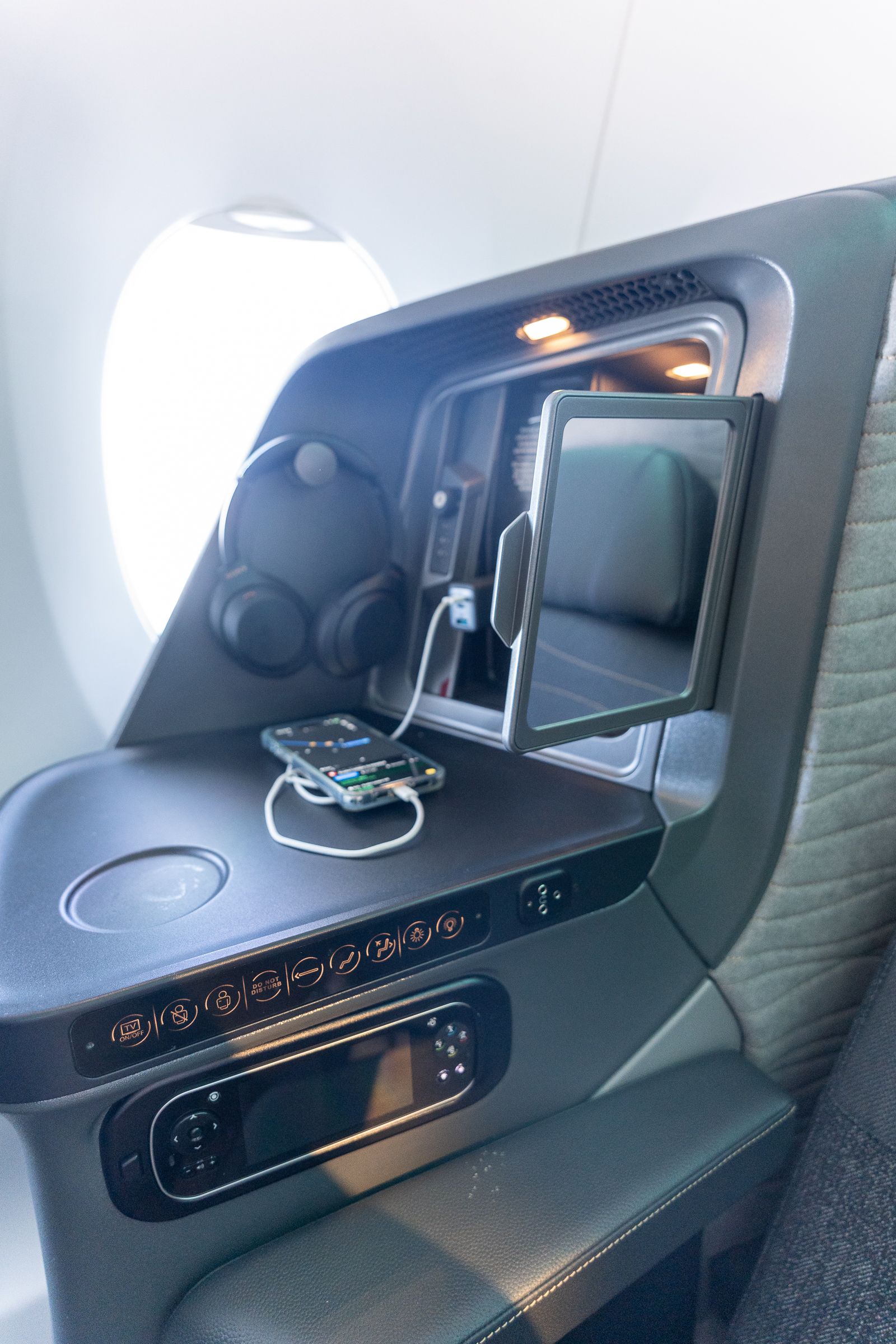 Side console with headphones and charging phone in Turkish Airlines A350 business class