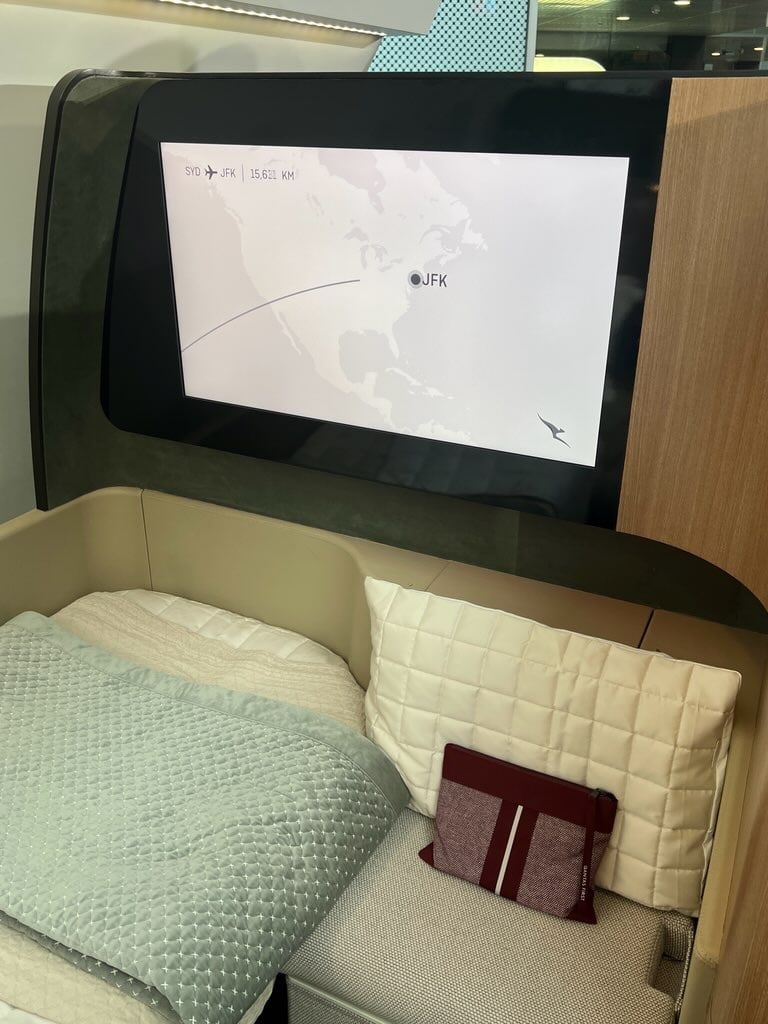 Bed in the Qantas A350 First Class prototype suite with a large screen