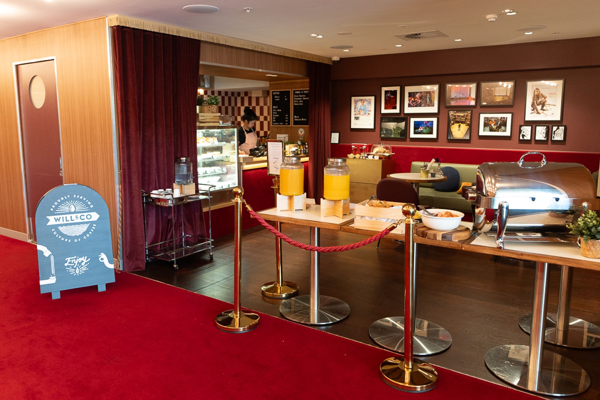 Breakfast buffet at Hotel Indigo Sydney with juice dispensers and a red carpet