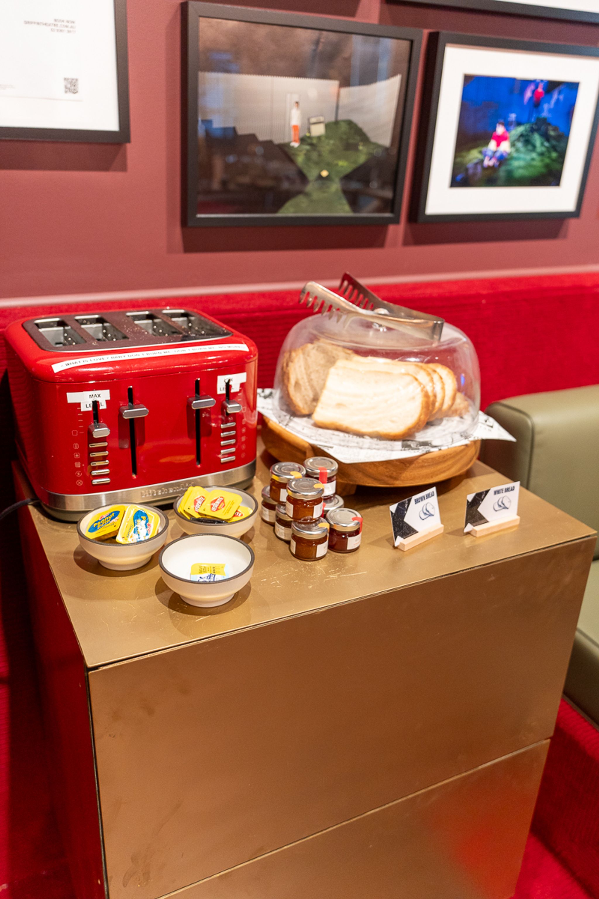 Breakfast station with a red toaster, bread and spreads at Hotel Indigo Sydney
