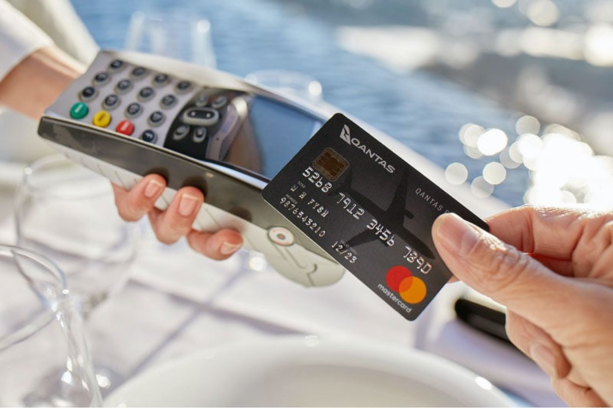 Qantas credit card being tapped on a payment terminal