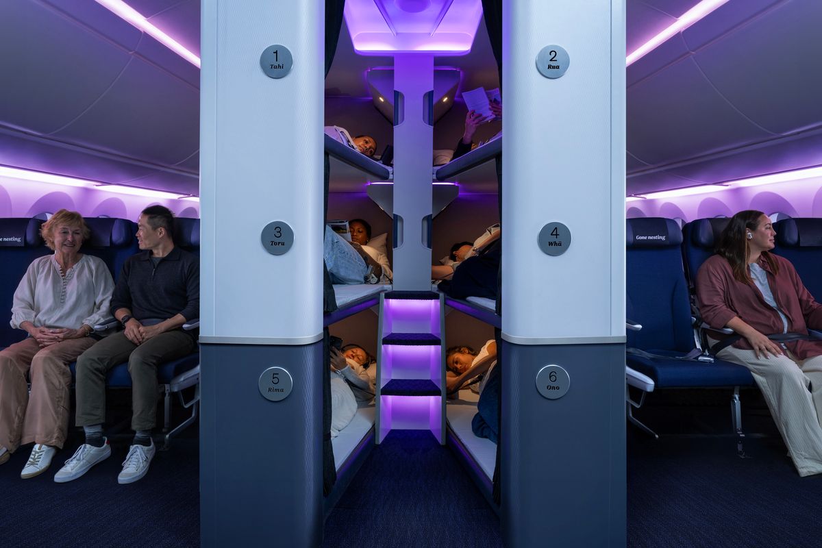 Air New Zealand Skynest sleep pods stacked between rows of Economy seats