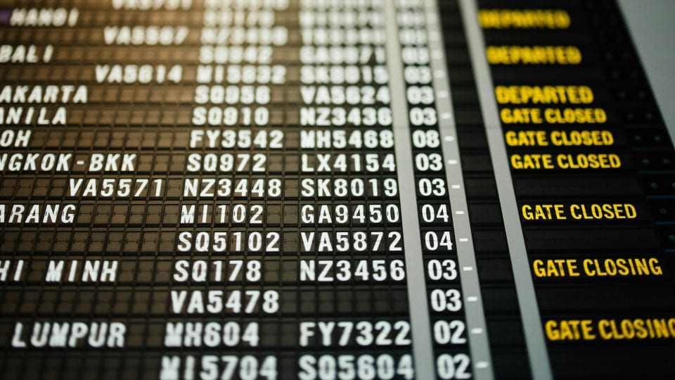 Airport departures board showing flights with gate closed and gate closing notices