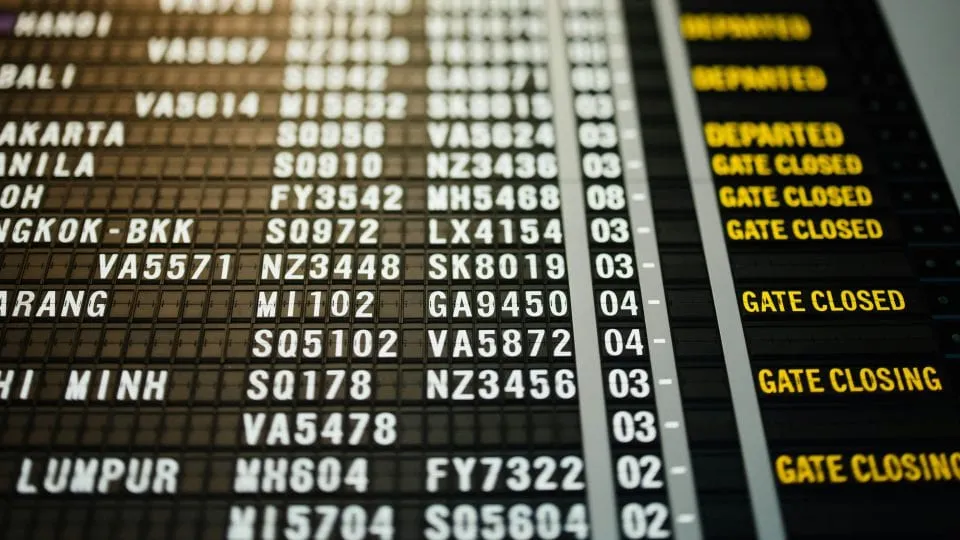 Airport departures board showing flights with gate closed and gate closing notices